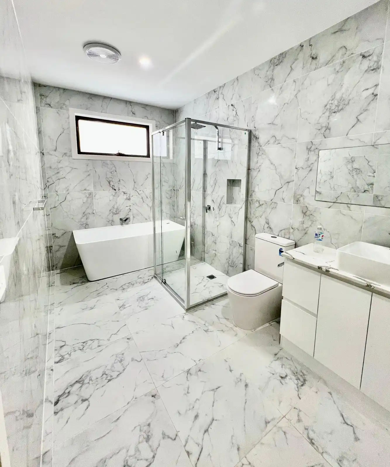 Ensuite shower recess with herringbone mosaic feature wall